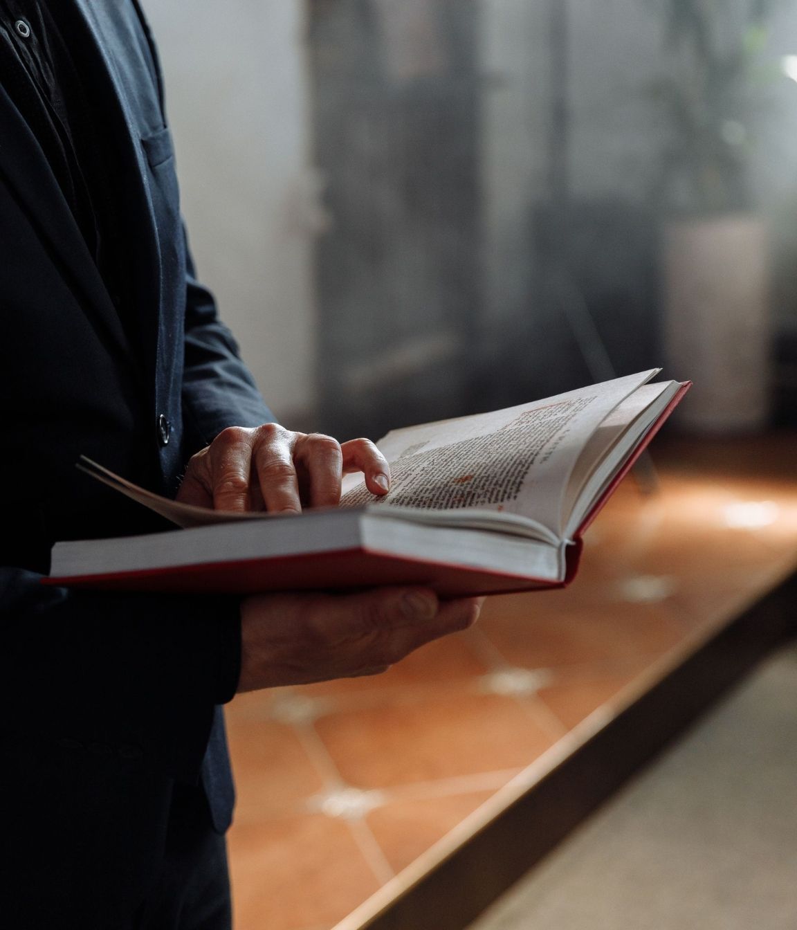 Clergy and Religious Counseling A man in a suit is reading the Bible