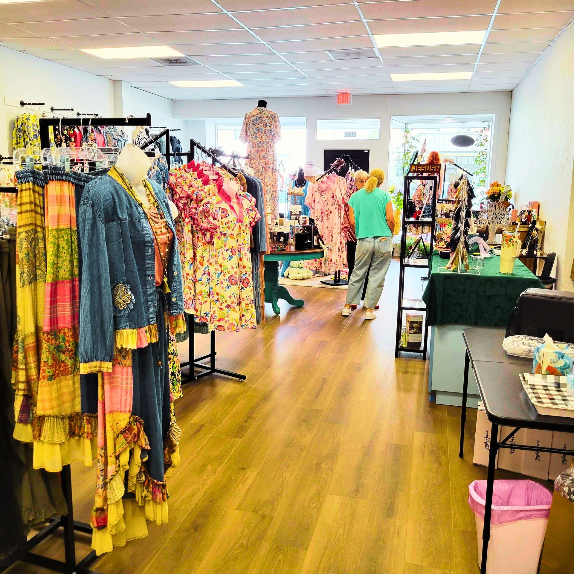 Dixie Darlin's Boutique shop housed in a white wooden building with a front porch, US and Texas flags, and a street sign.