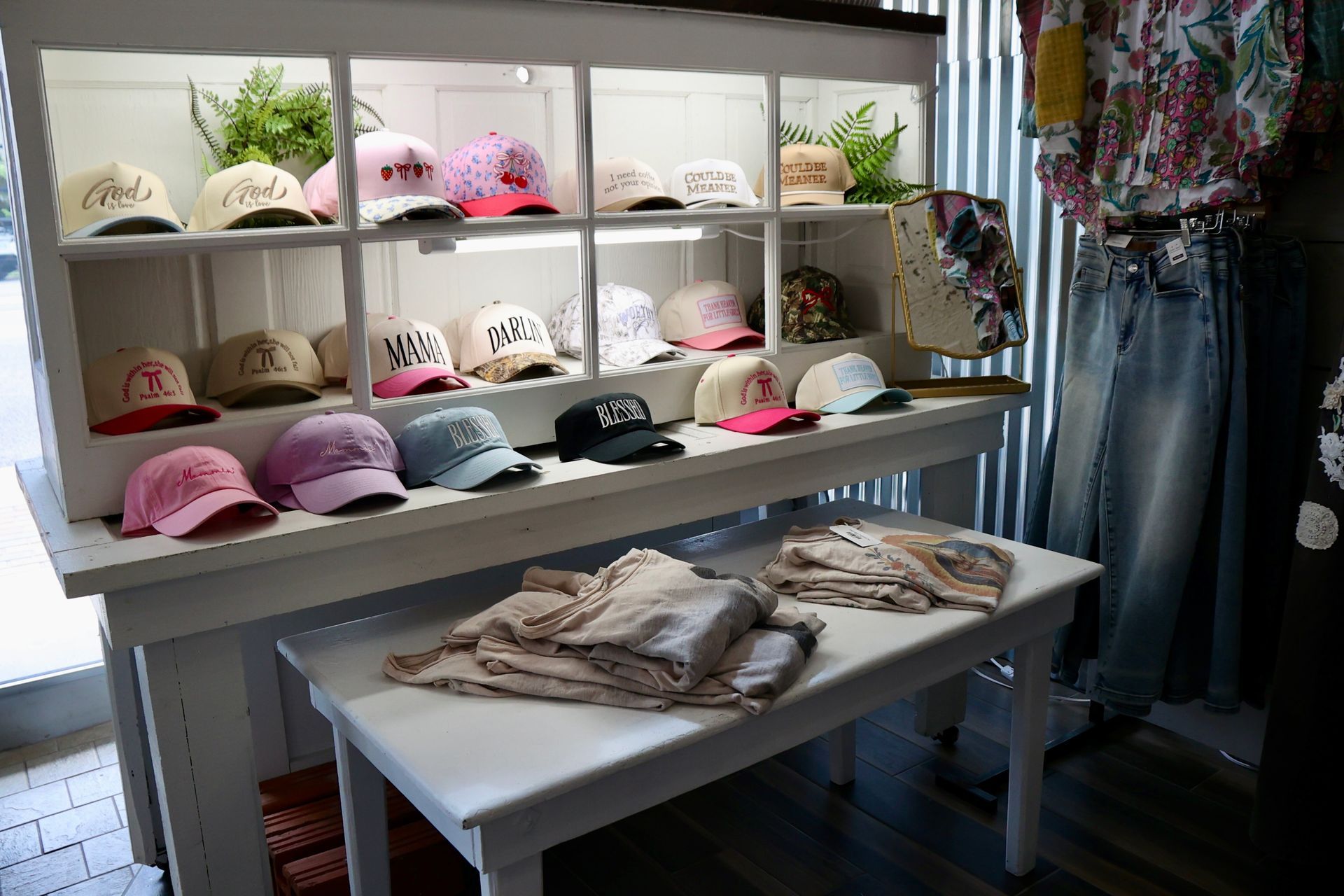 Hats on display in store window.