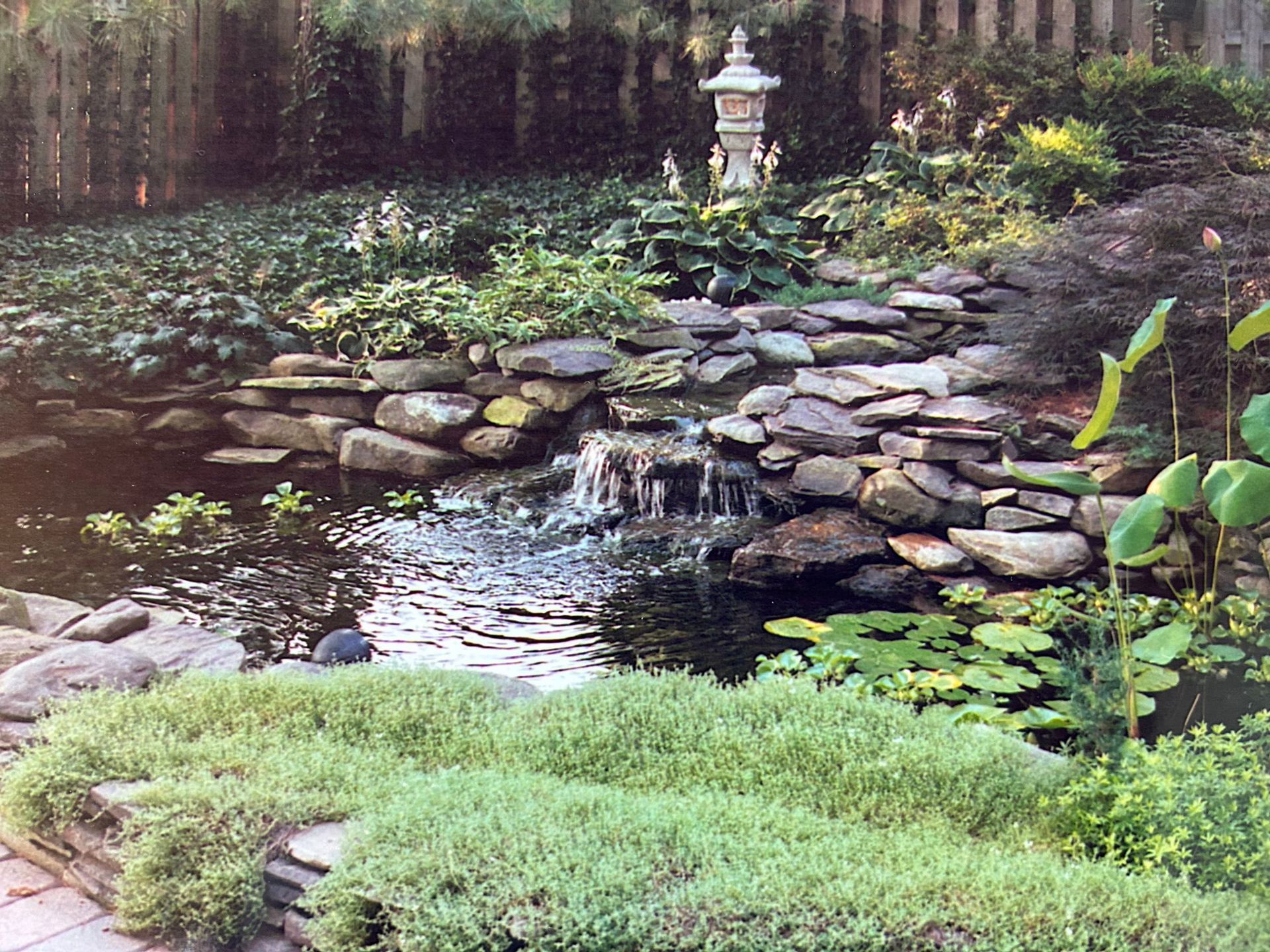 A pond with a waterfall in the middle of it