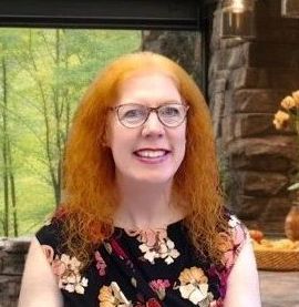 A man and a woman are hugging each other and smiling for the camera.