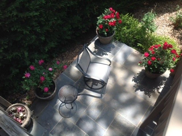 An aerial view of a patio with chairs and flowers