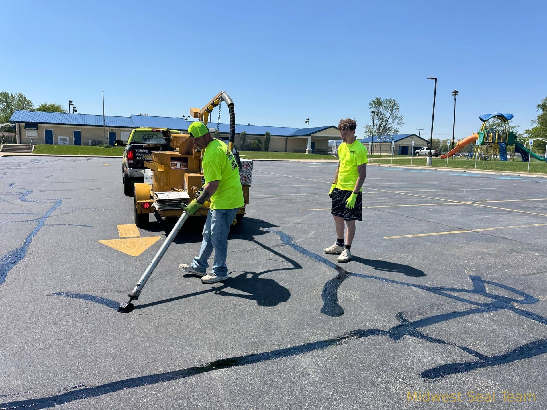Image of Midwest Seal Team crack filling in a parking lot. You can see the Midwest Seal Team crack filling crew sealing cracks in a parking area here in Van Wert Ohio.