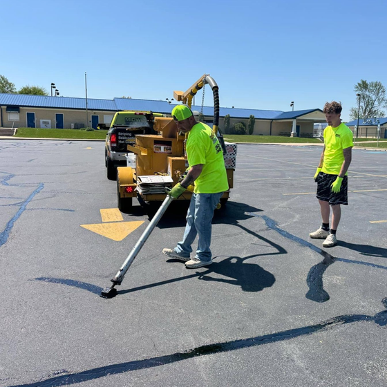 Image of Midwest Seal Team crack filling in a parking lot. You can see the Midwest Seal Team crack filling crew sealing bracks in a parking area here in Fort Wayne, Indiana.