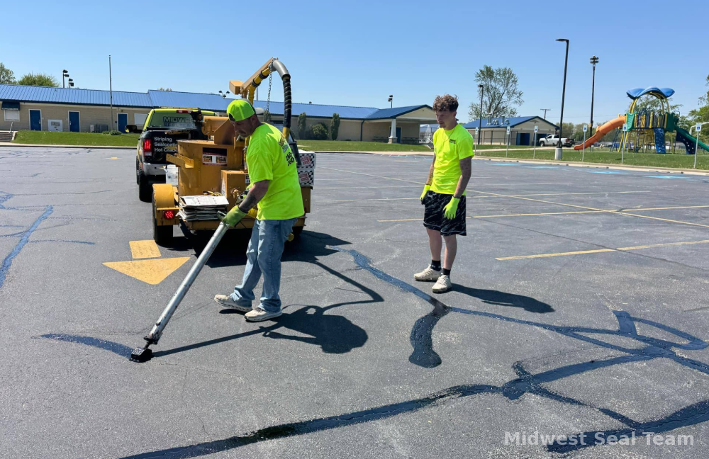 Image of Midwest Seal Team crack filling in a parking lot. You can see the Midwest Seal Team crack filling crew sealing cracks in a parking area here in Bluffton, Indiana.