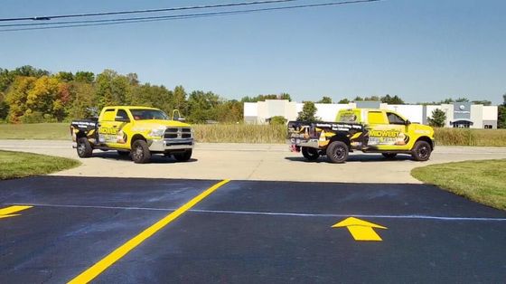 Image showing Midwest seal team truck. You can see a freshly sealed driveway of commercial business.