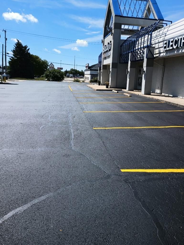 Picture of a close-up view capturing  parking lot painting services carried out by Midwest Seal Team in a commercial parking lot in Fort Wayne, IN.
