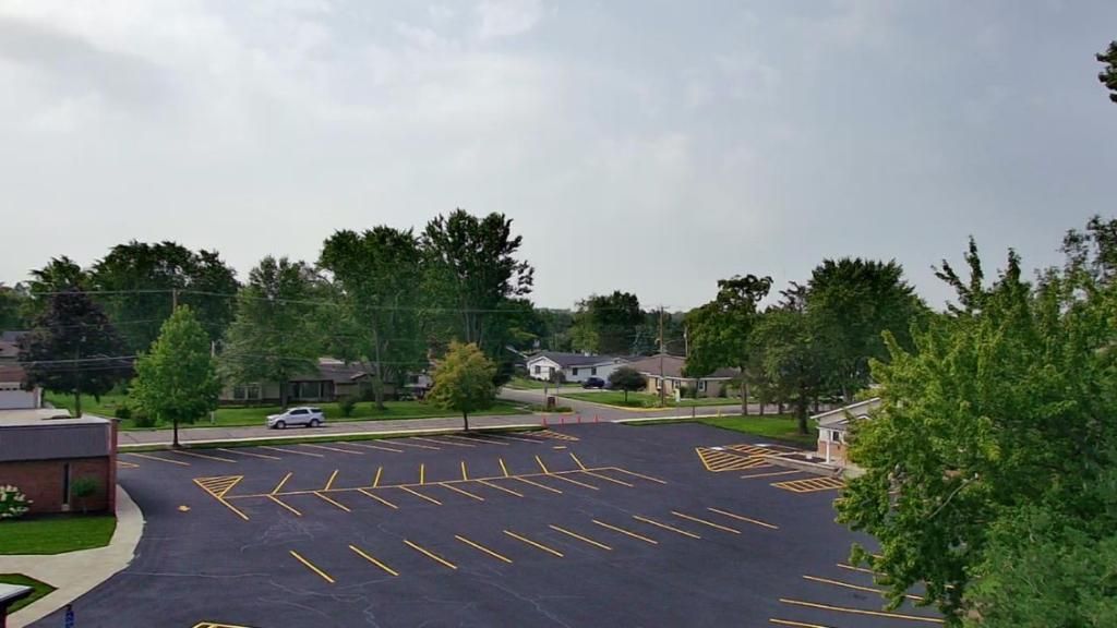 Picture of a seamless application of parking lot painting by Midwest Seal Team on the surface of a commercial parking lot in Fort Wayne, IN.
