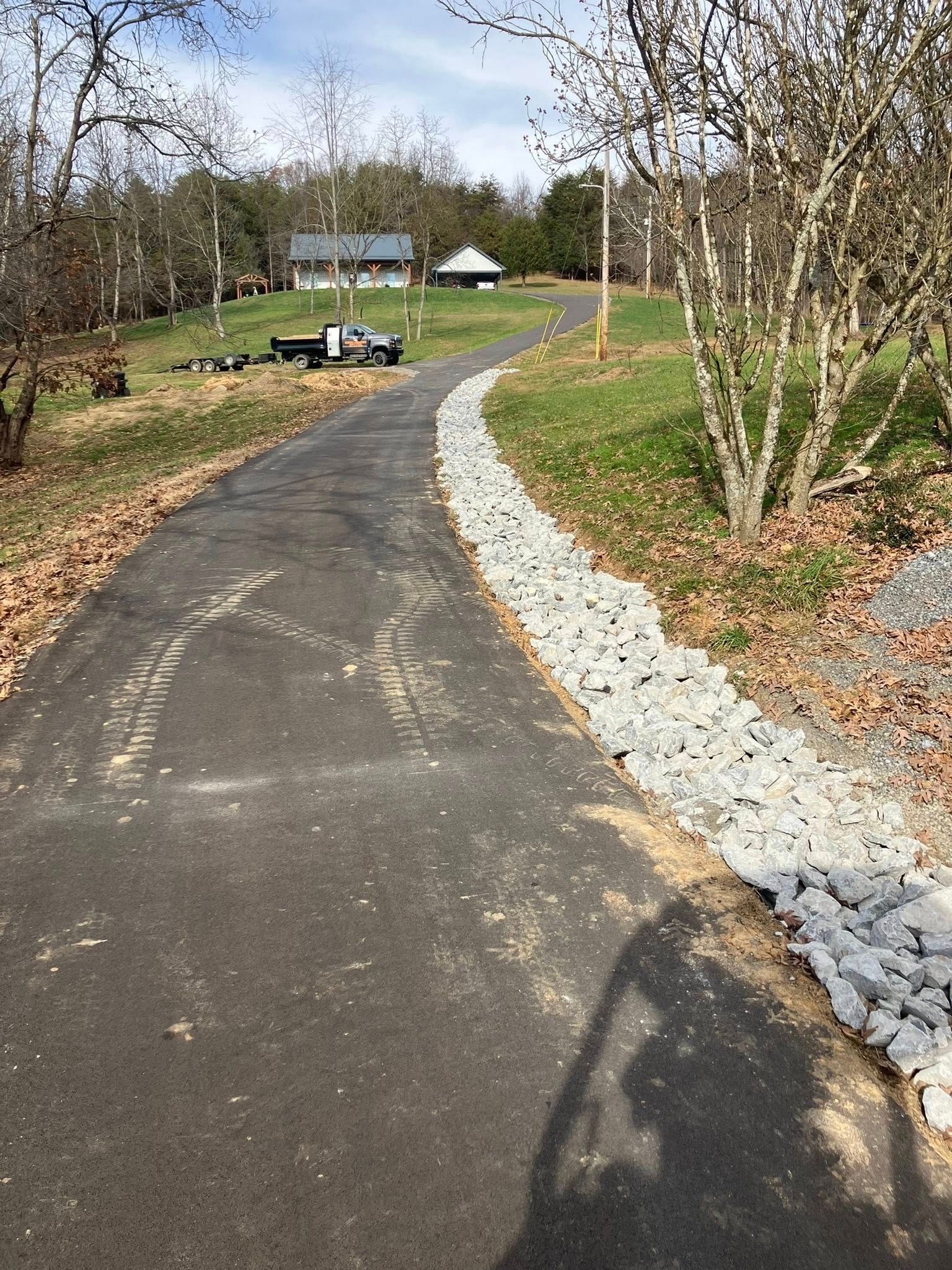 Red semi-truck driving on a highway at sunset, with a second truck visible in the distance.