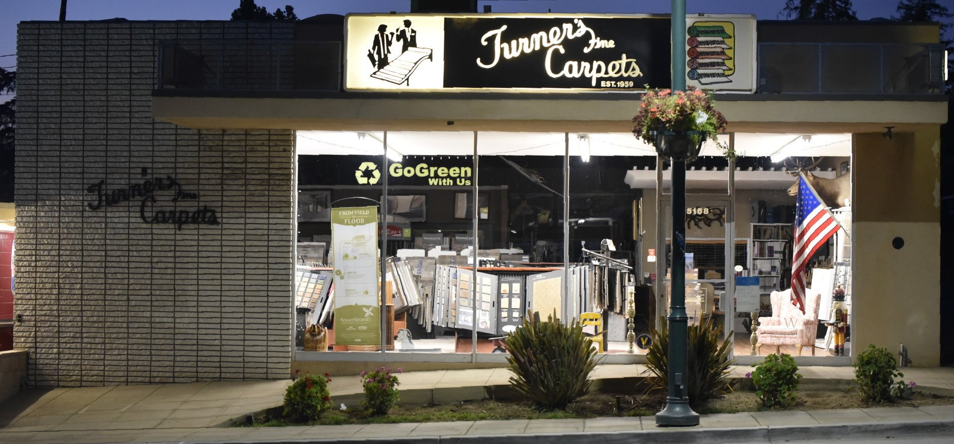 Color photo of Turner's Carpets flooring store in Yucaipa CA Looking in showroom at night