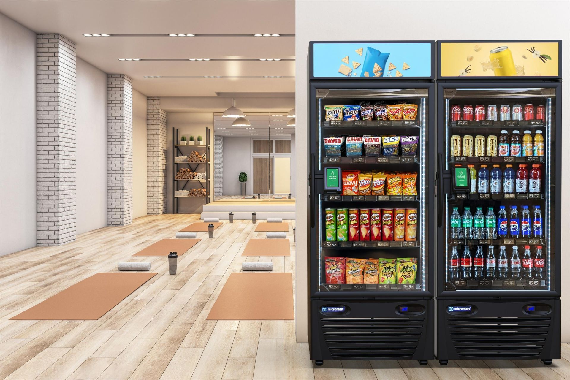 Yoga studio with mats on wooden floor, and two vending machines with snacks and drinks.