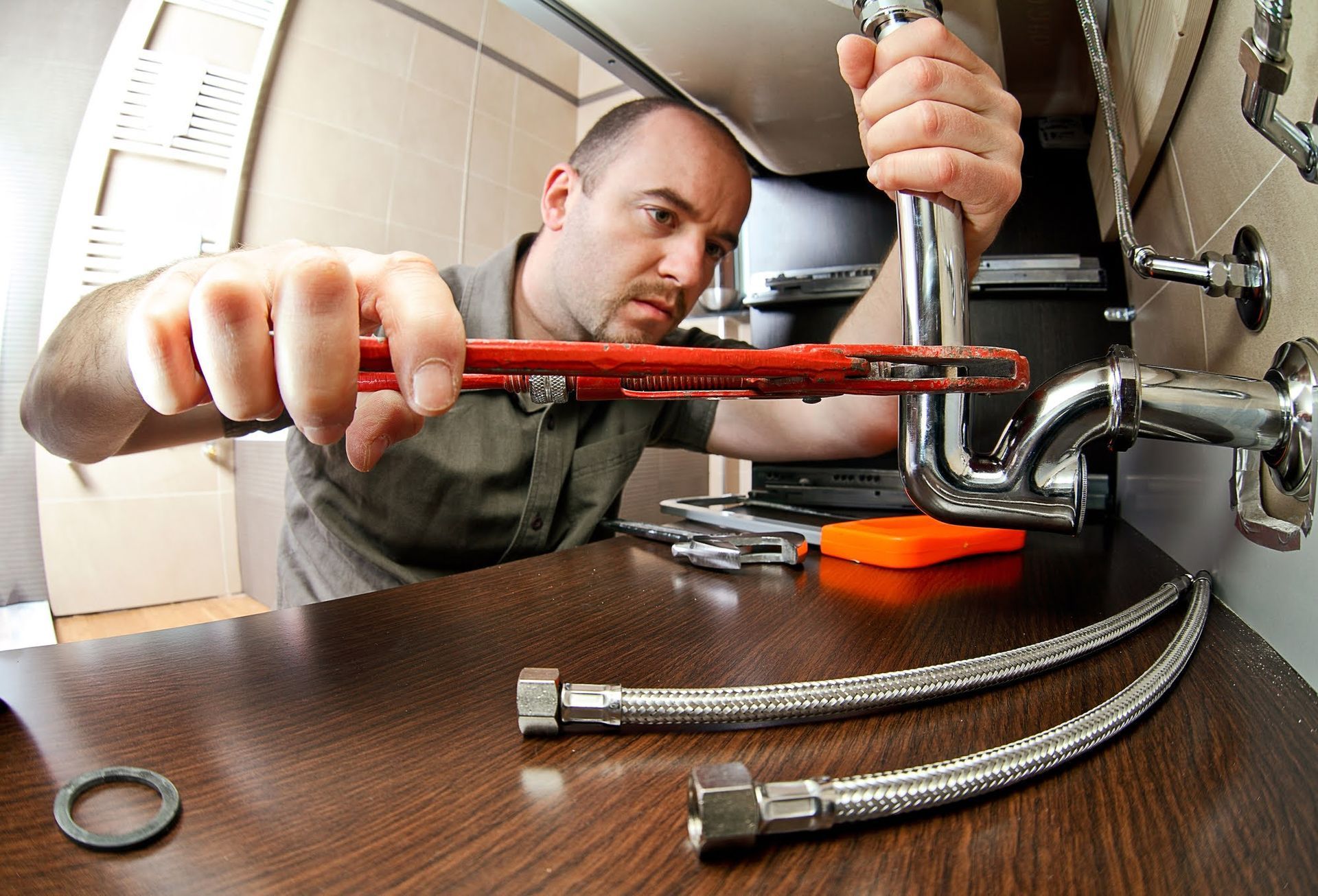Man Fixing Faucet - Santa Barbara, CA - Lewis Plumbing Inc.