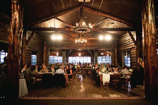 A group of people are sitting at tables in a large room.