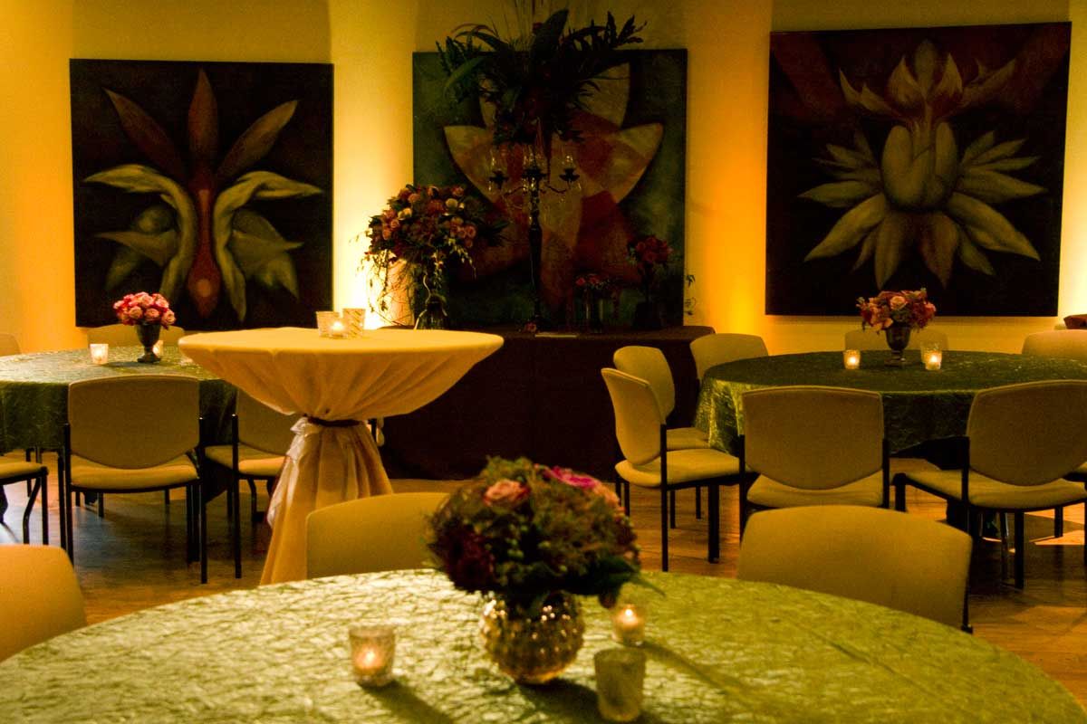 A room with tables and chairs and flowers on them