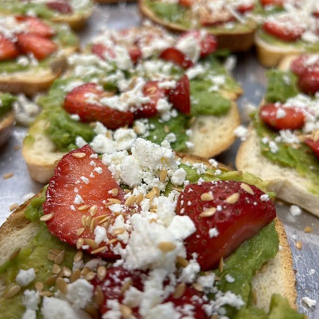 A close up of a sandwich with strawberries and cheese