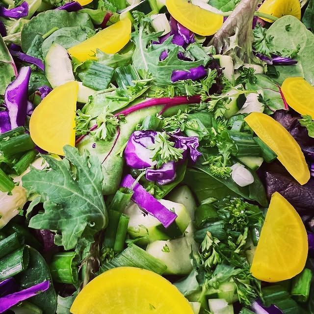 A salad with purple cabbage and yellow slices