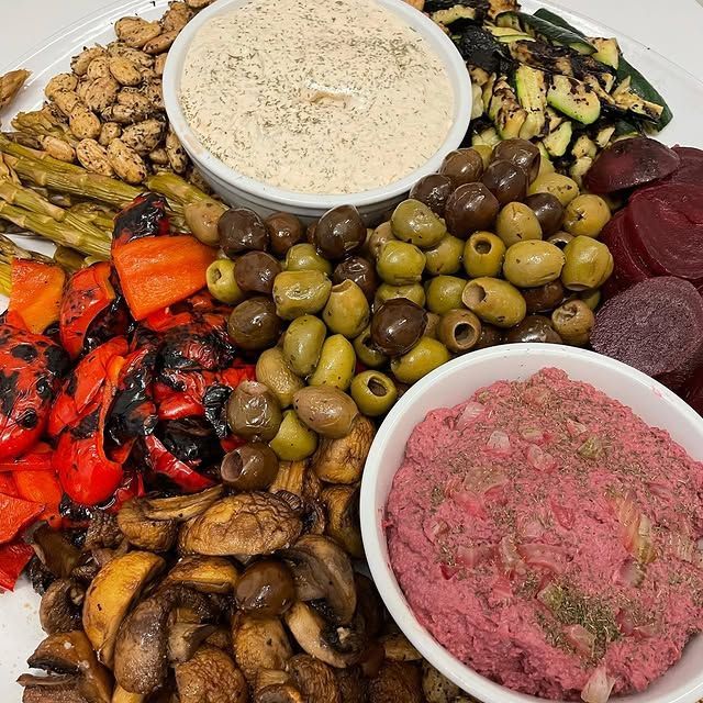 A variety of vegetables and dips on a plate