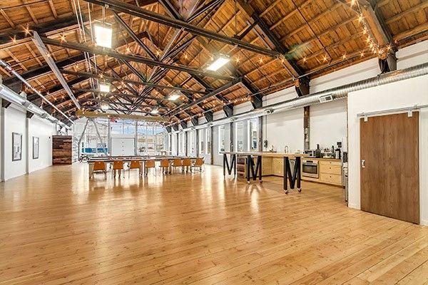 A large room with a wooden floor and a wooden ceiling.