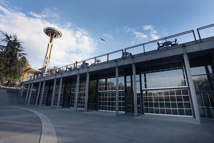 A large building with a very tall tower in the background.