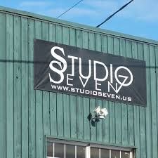 A studio seven sign is hanging on the side of a building.