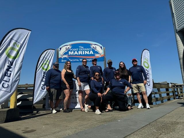 A group of people standing in front of a marina sign