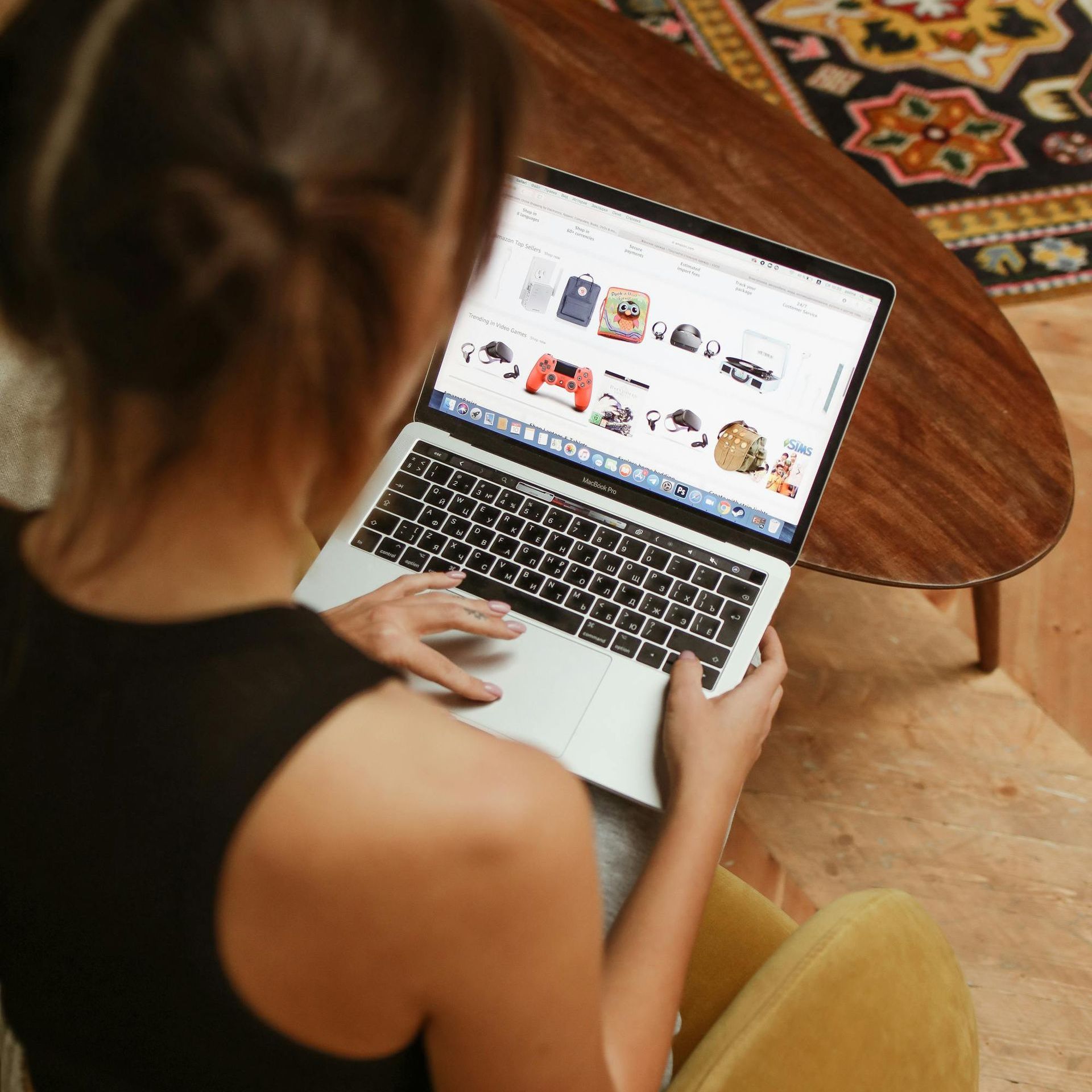 A woman is sitting at a table using a laptop computer