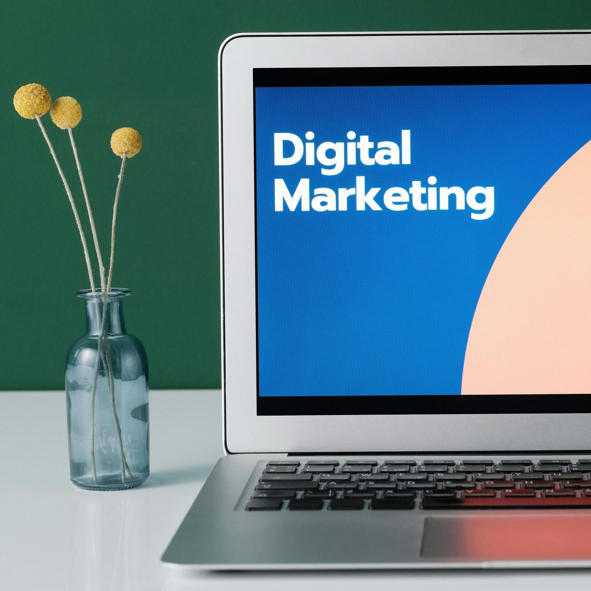 A laptop is open to a screen that says digital marketing