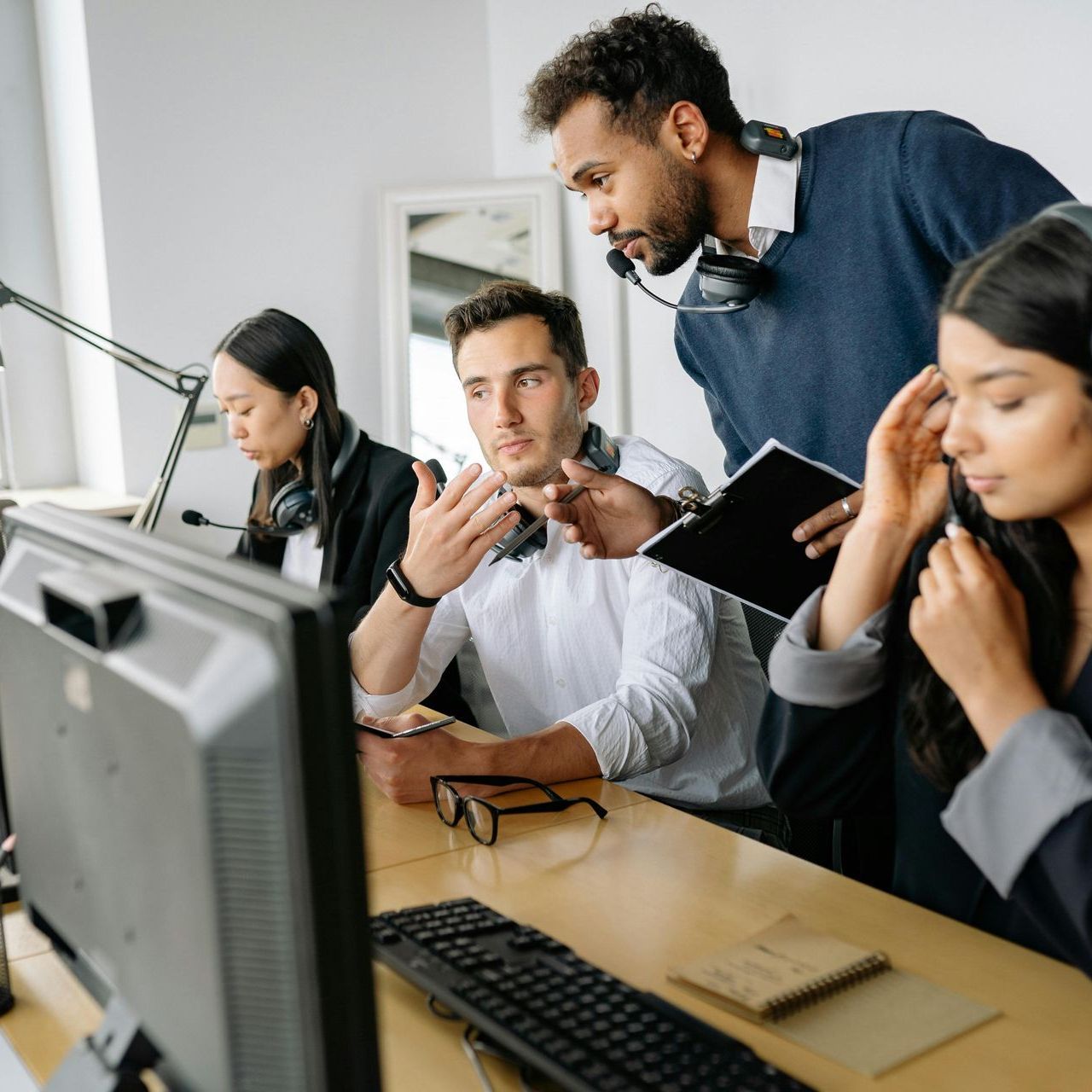 A group of people are looking at a computer screen.