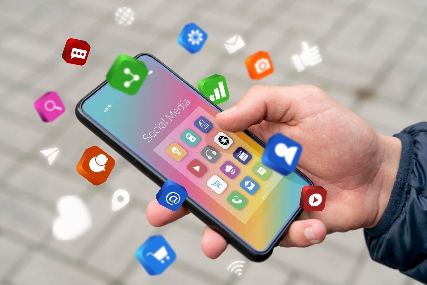 A person is holding a smart phone in their hand surrounded by social media icons.