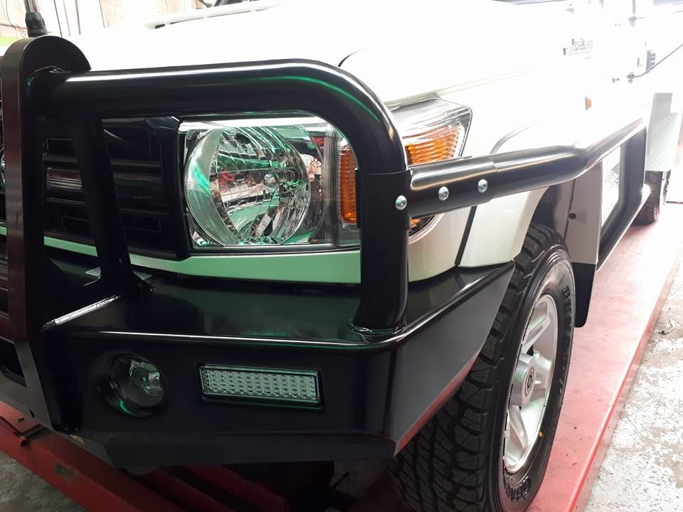 A White Truck With A Black Bumper Is Parked On A Red Table — Goulburn Automotive Centre In Goulburn, NSW