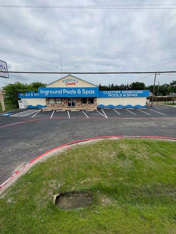 A large building with a lot of parking spaces in front of it.
