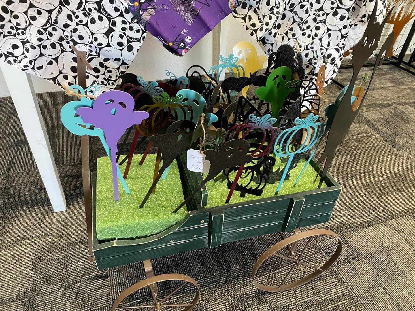 Halloween-themed wagon decoration with various cutouts of ghosts and foliage on green foam.