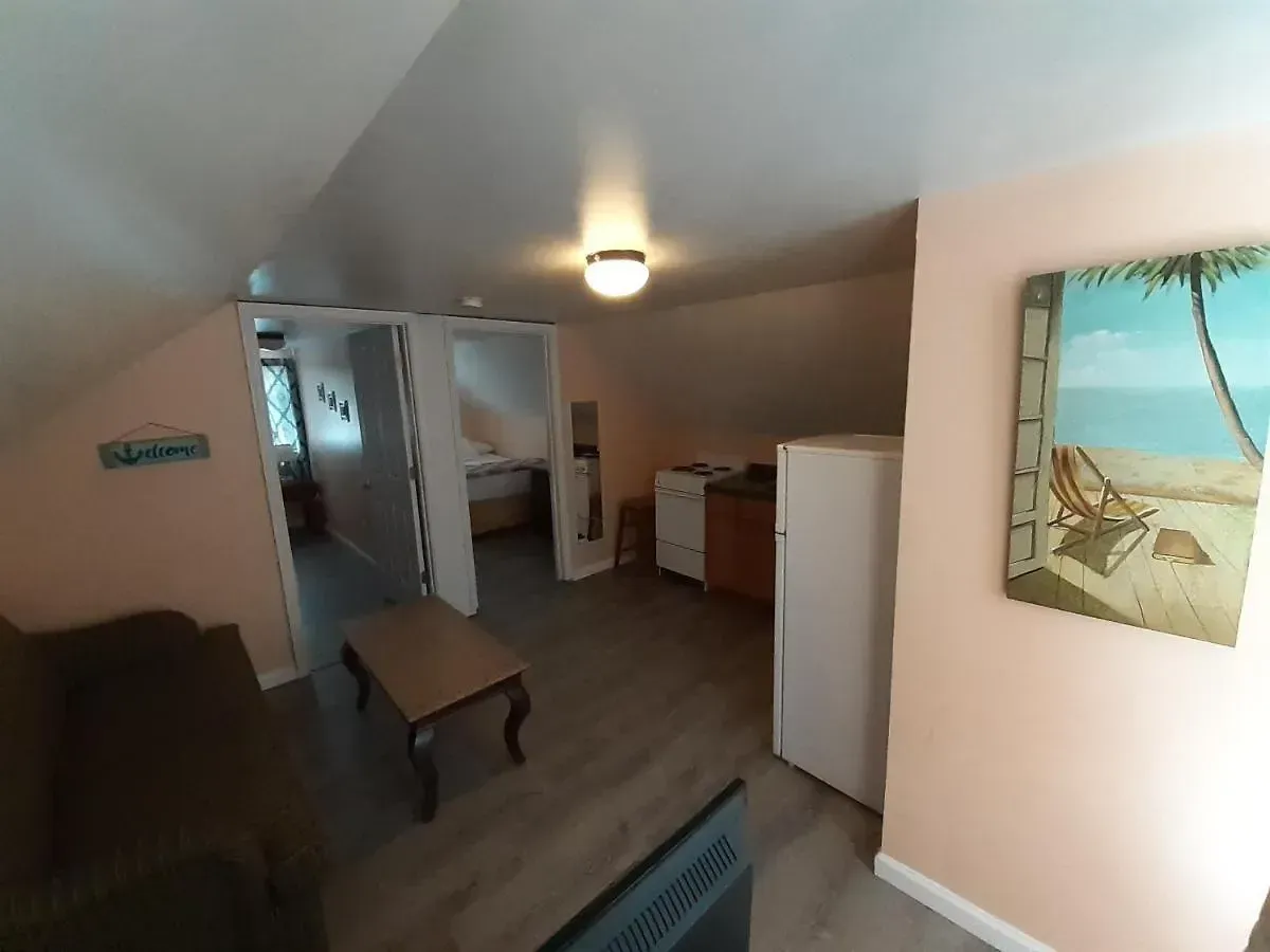 A living room with a painting of a beach chair on the wall