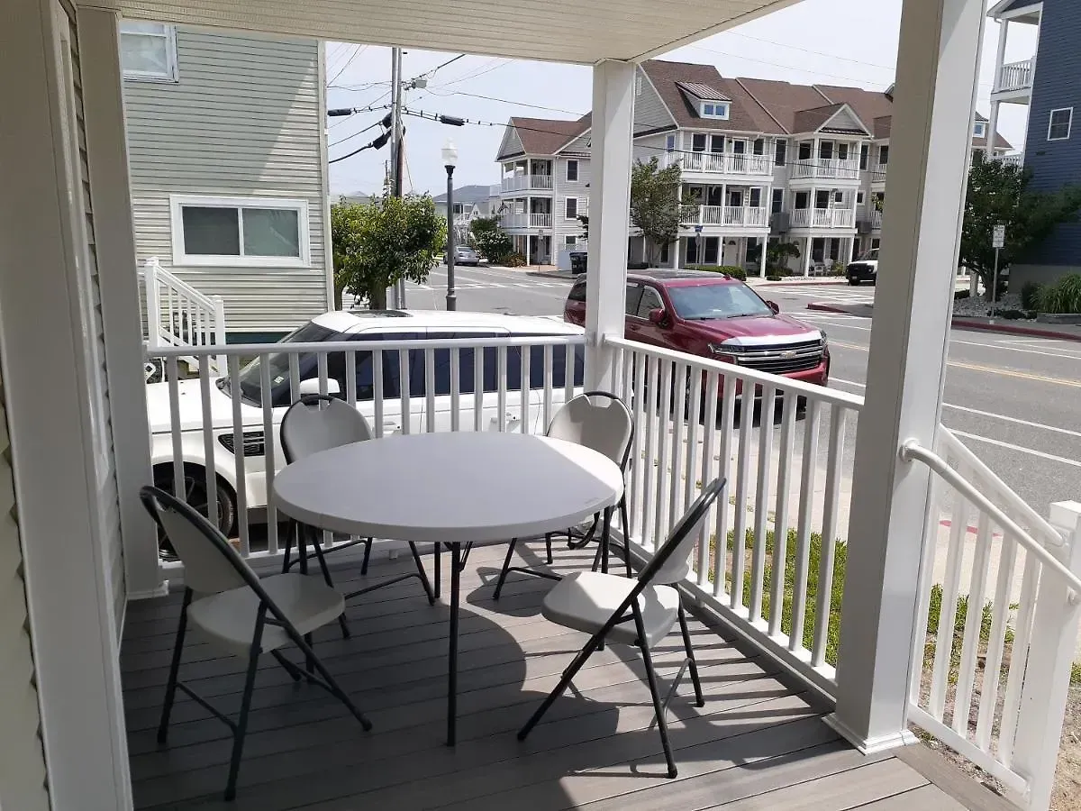 A porch with a table and chairs on it