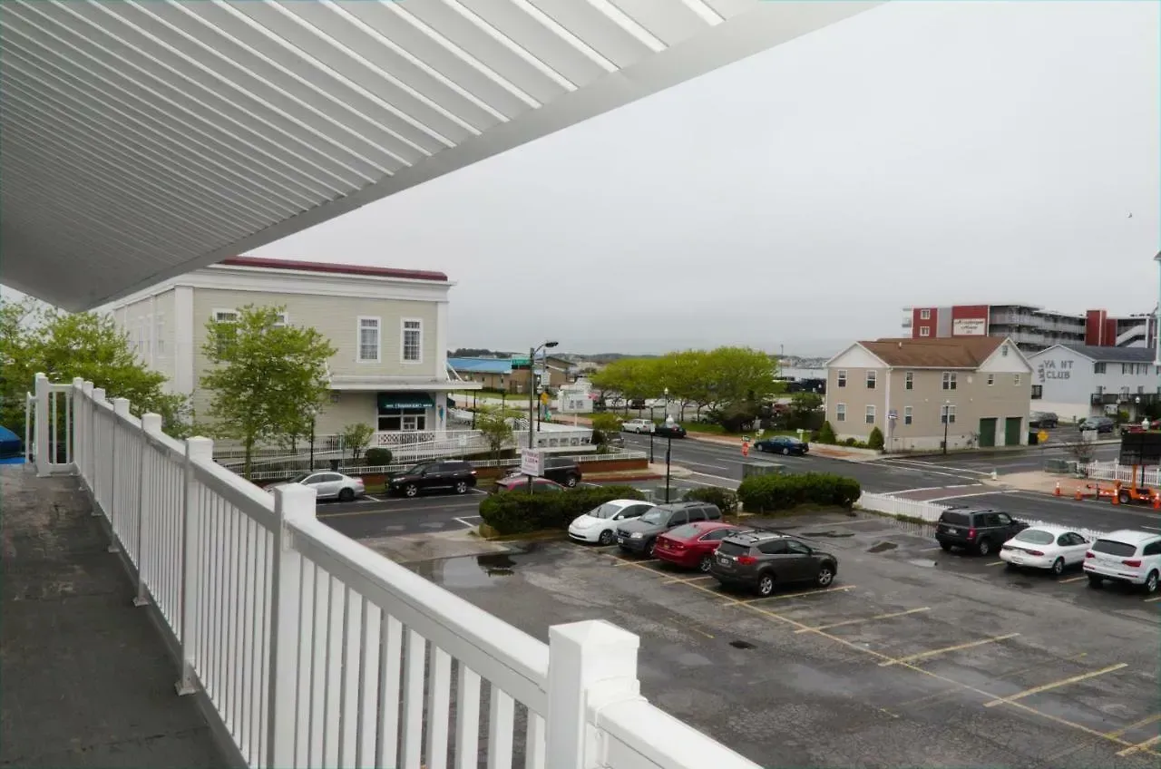 A view of a parking lot from a balcony with a white railing