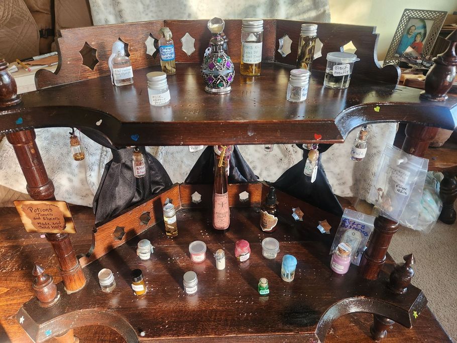 A wooden table with many small bottles on it