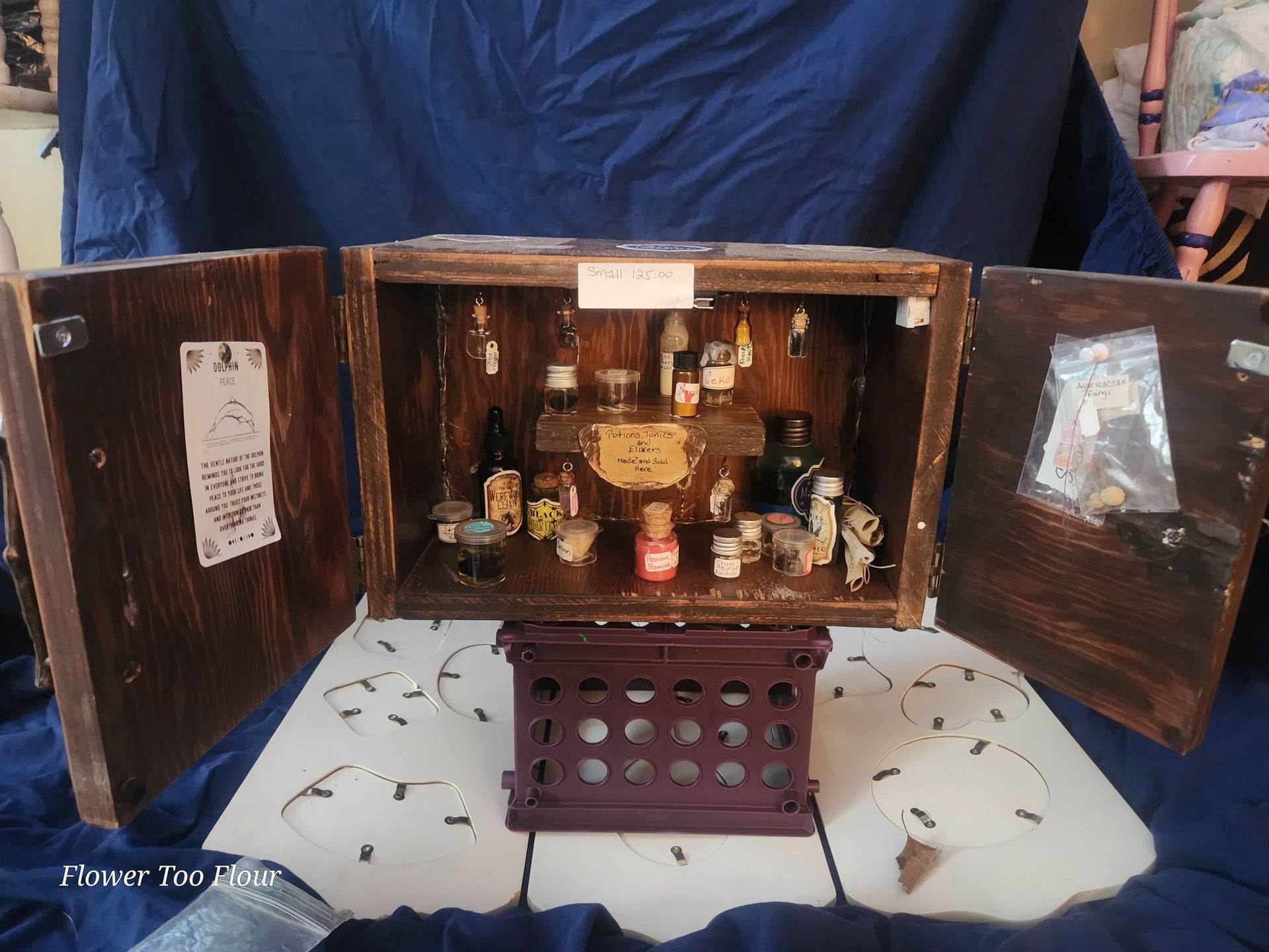 A wooden box with a lot of bottles inside of it