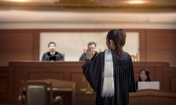 Attorney speaking in a courtroom before judges on the bench