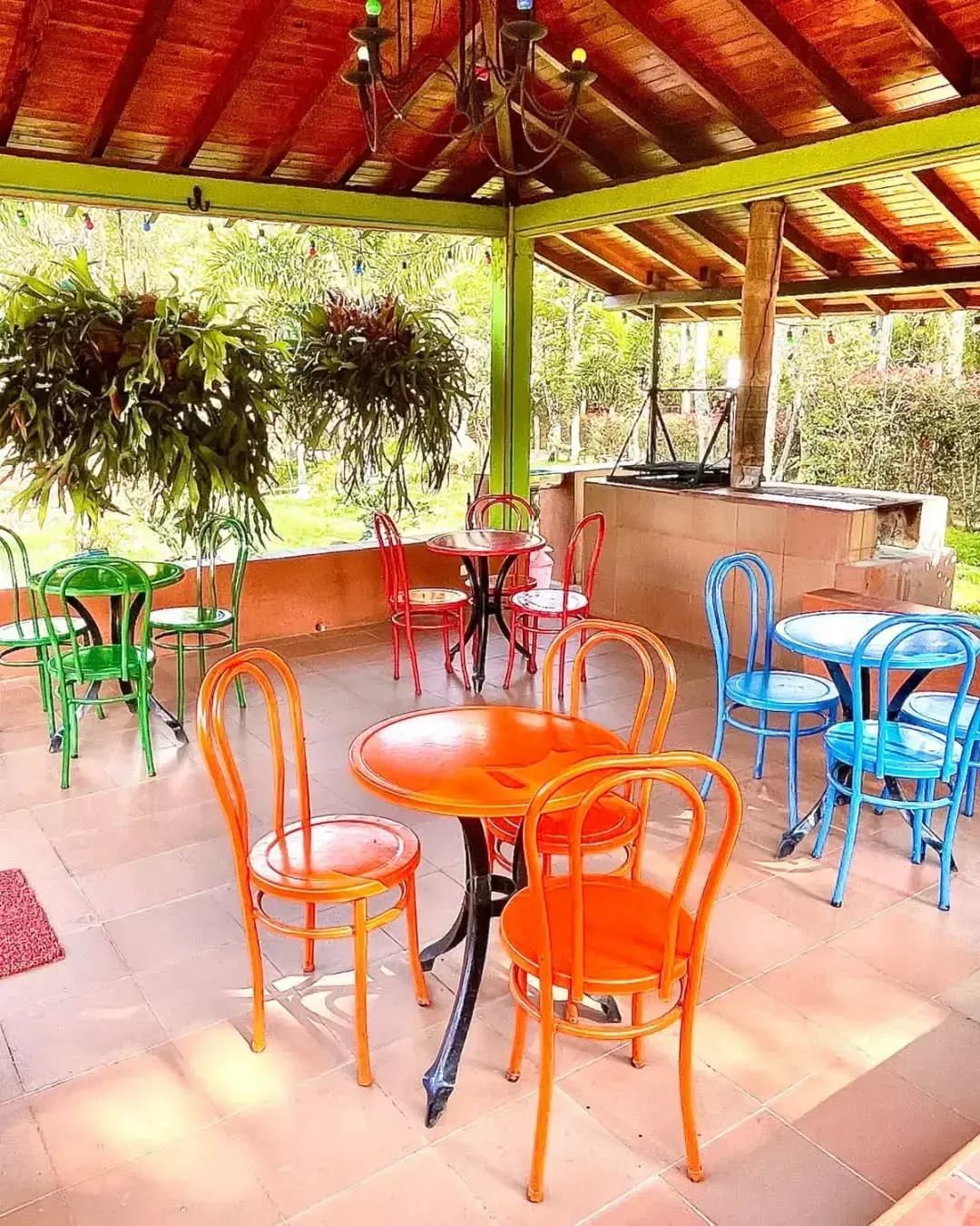 A patio with tables and chairs under a canopy