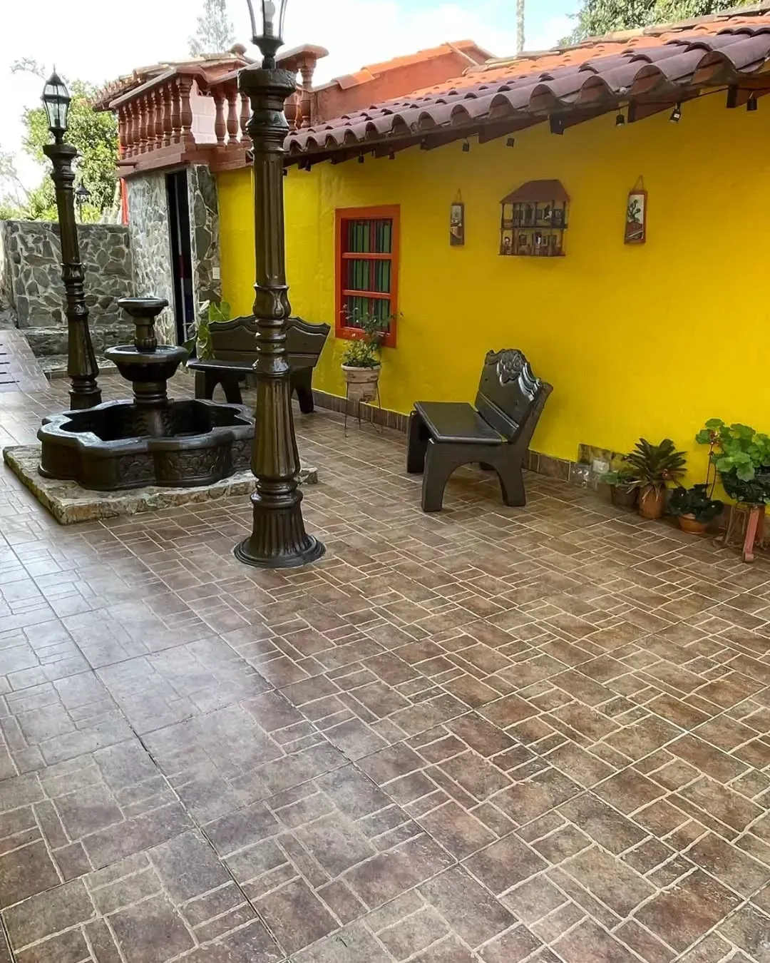 A yellow building with a fountain in front of it