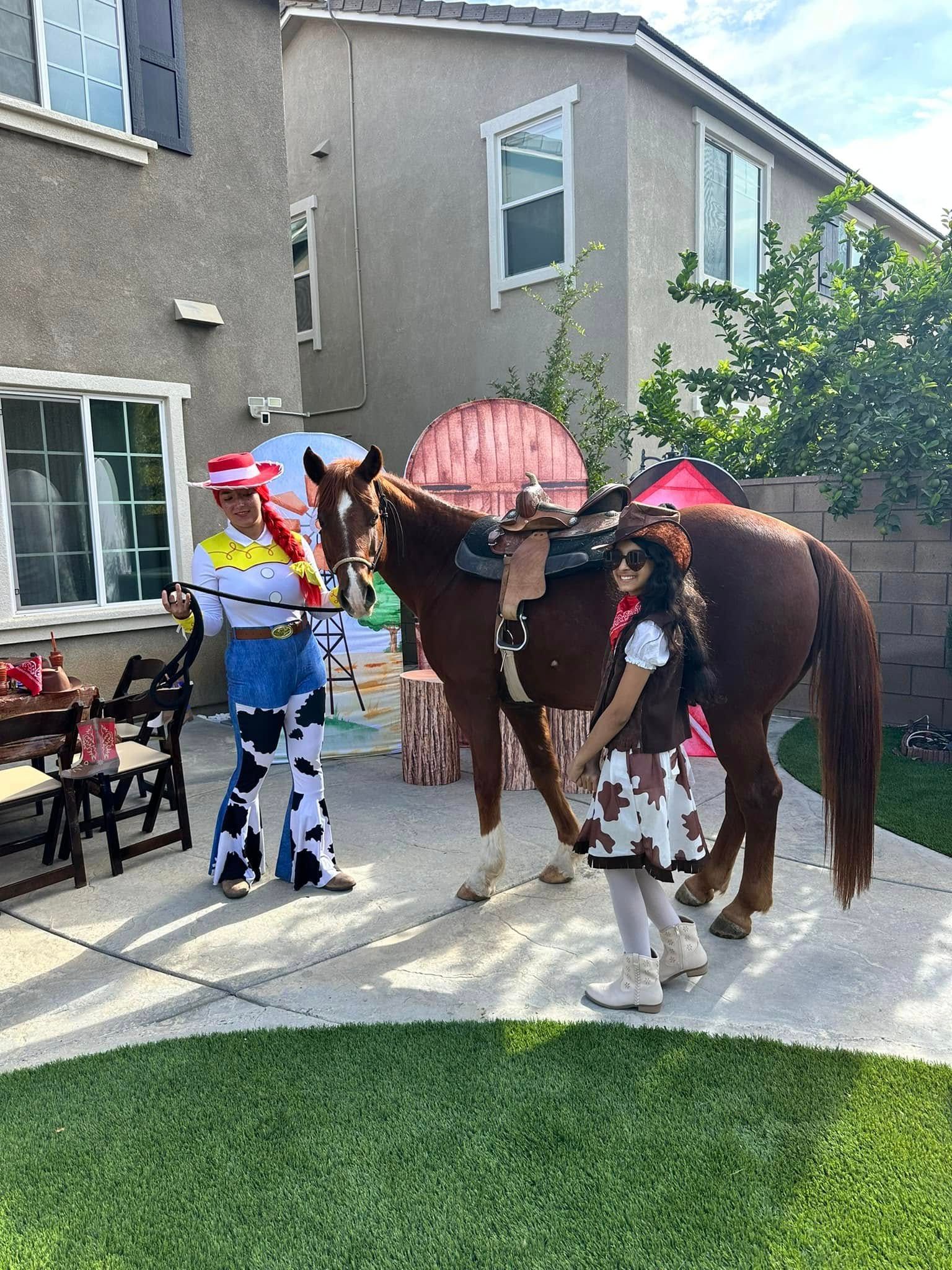 A man and a girl are standing next to a horse.