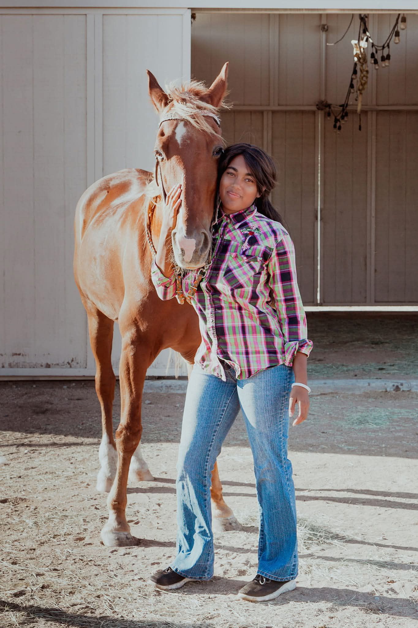 A woman and two girls are riding on the back of a brown horse.