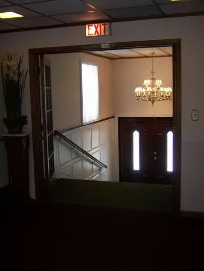 A room with a red exit sign above the door