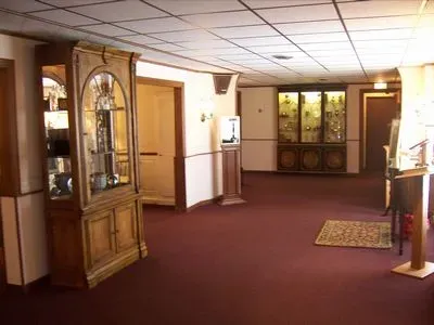 A hallway with a display case in the middle of it