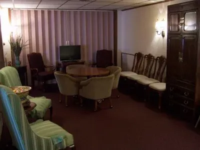 A living room with a table and chairs and a television.