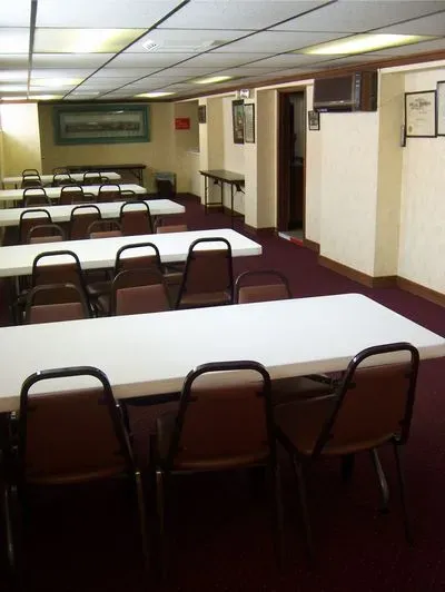 A large room with tables and chairs in it