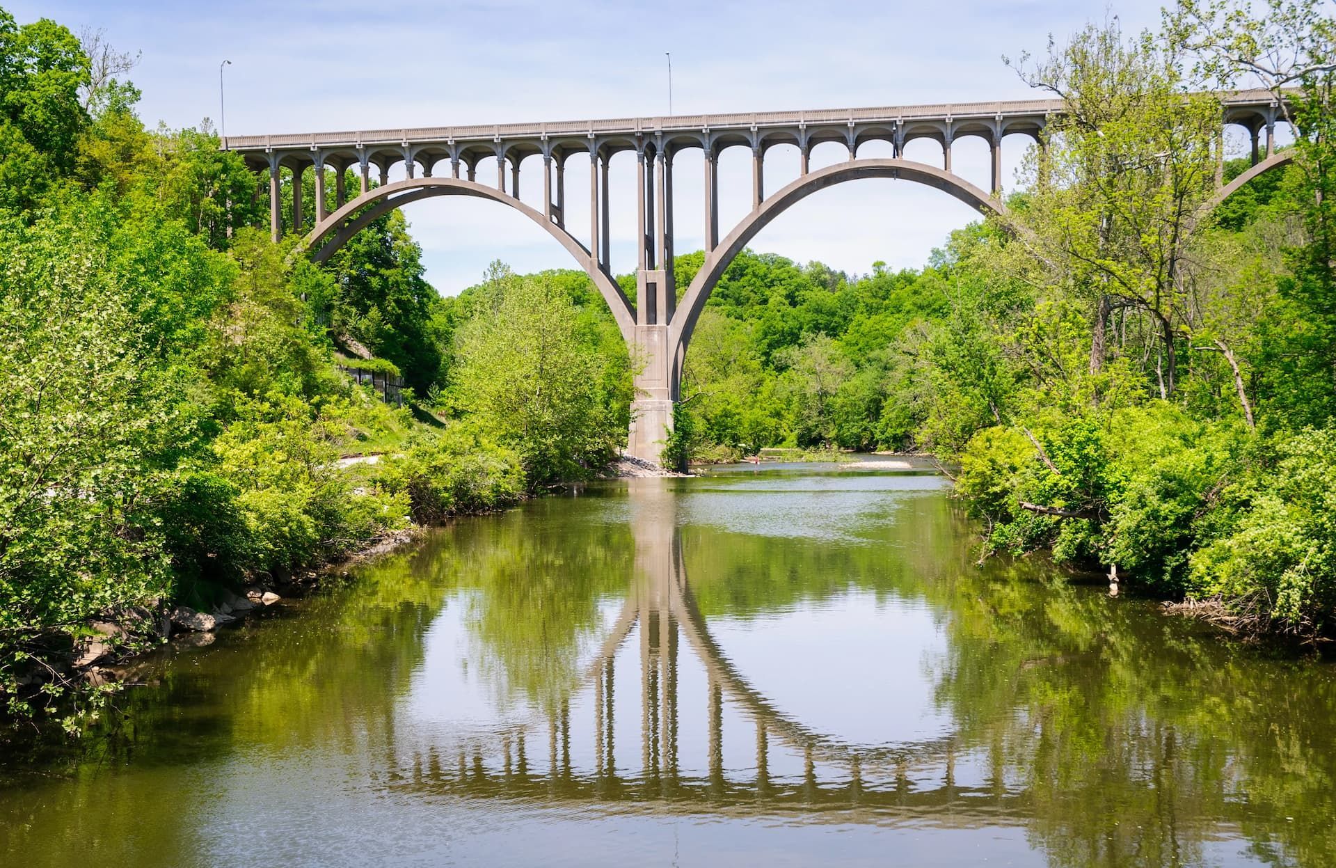 A bridge over a river with trees in the background