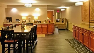 There is a long table and chairs in the middle of the room.