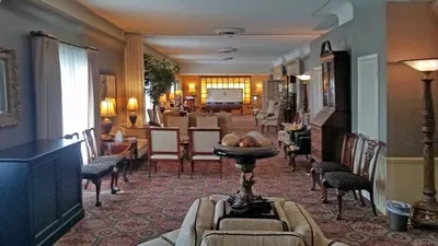 A living room filled with furniture and a table.
