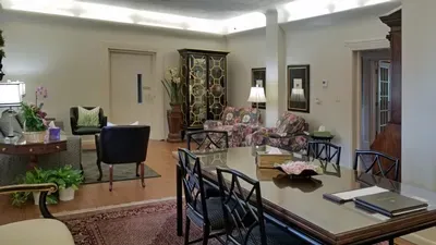 A living room with a dining table and chairs and a couch.